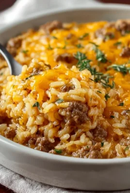 Delicious cheesy hamburger rice casserole served in a baking dish