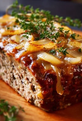 Delicious French Onion Meatloaf served with caramelized onions and melted cheese.