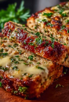 Delicious Garlic Parmesan Chicken Meatloaf served on a plate with herbs