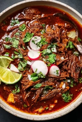 Delicious Mexican beef birria served with traditional toppings