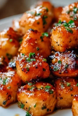 Delicious air fryer honey garlic salmon bites served on a plate.