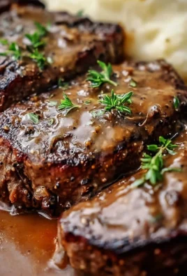 Amish Poor Man's Steak served with sides on a rustic plate.