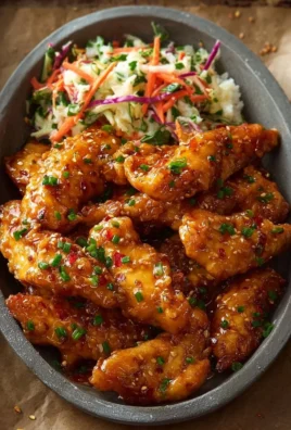 Delicious Bang Bang Chicken served with spicy sauce and garnishes
