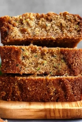 Deliciously baked zucchini bread with walnuts on a wooden table