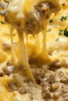 Cheddar Bay Hamburger Casserole topped with cheese and herbs.