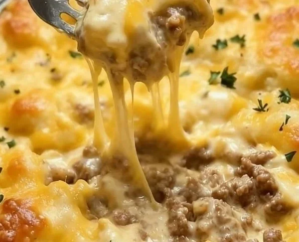 Cheddar Bay Hamburger Casserole topped with cheese and herbs.