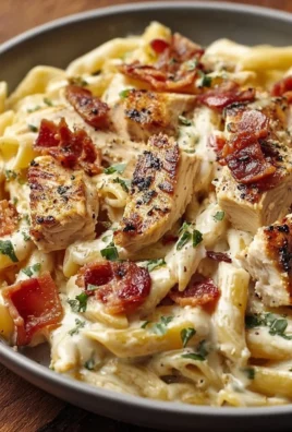 Creamy Chicken Bacon Ranch Pasta topped with crispy bacon and herbs