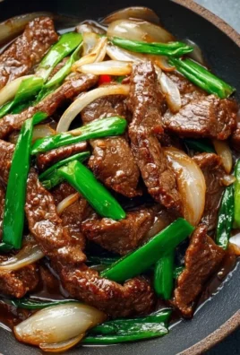 Chinese Beef and Onion Stir Fry dish served in a bowl.