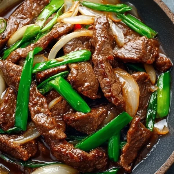 Chinese Beef and Onion Stir Fry dish served in a bowl.