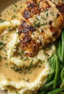 Creamy Garlic Parmesan Chicken Breast served with herbs and spices.