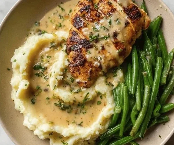 Creamy Garlic Parmesan Chicken Breast served with herbs and spices.