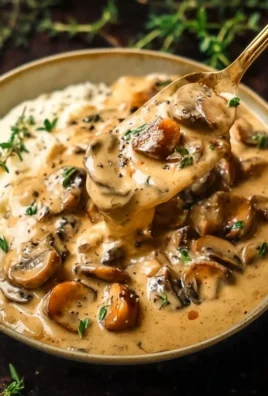 Creamy mushroom sauce served over pasta with herbs