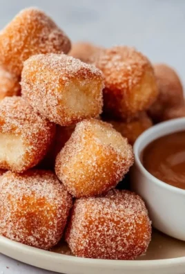 Plate of crispy air fryer churro bites dusted with cinnamon sugar