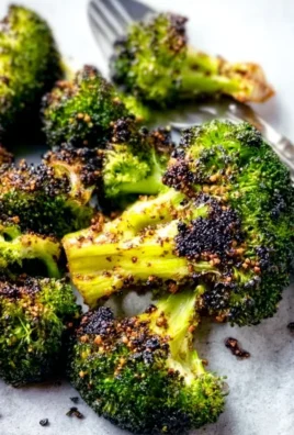 Tray of crispy oven roasted broccoli seasoned with herbs and spices