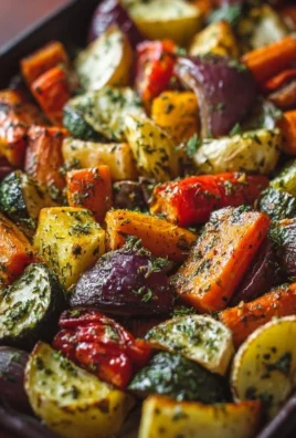 Bowl of garlic herb roasted veggies including bell peppers, zucchini, and carrots