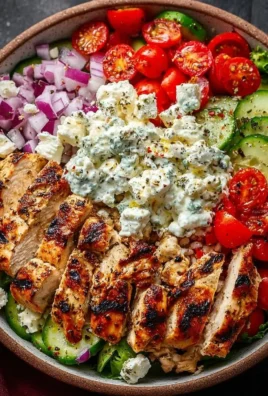 Delicious Greek chicken bowl with fresh vegetables and zesty toppings