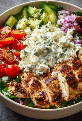 Healthy and delicious Greek Chicken Bowl with fresh veggies and savory dressing