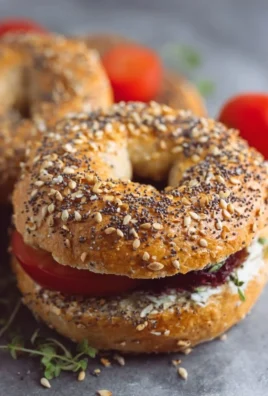 Homemade protein bagels with toppings on a wooden board
