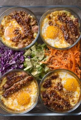 Colorful meal prep breakfast bowls with healthy ingredients and toppings.