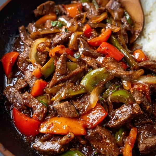 Delicious homemade pepper steak served with colorful bell peppers and tender beef.