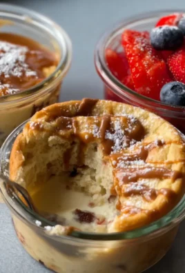 Fluffy baked protein pancake bowls topped with fruits and syrup