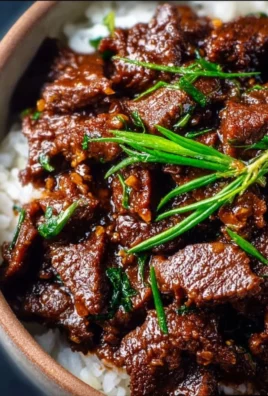 Delicious Slow Cooker Mongolian Beef served with rice and vegetables