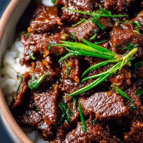 Delicious Slow Cooker Mongolian Beef served with rice and vegetables
