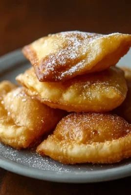 Delicious golden sopaipillas served with honey and powdered sugar