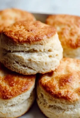 Freshly baked sourdough discard biscuits on a wooden table