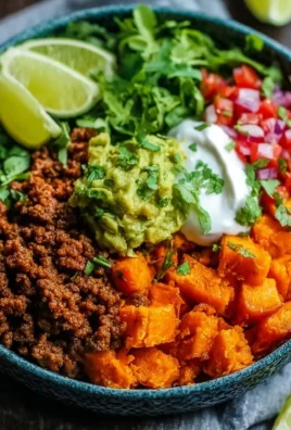 Colorful sweet potato taco bowl filled with fresh ingredients and toppings.