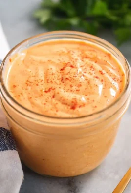 Bottle of Yum-Yum Sauce with a delicious dip and fresh vegetables