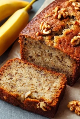 Delicious slice of homemade Banana Nut Bread topped with walnuts and bananas.