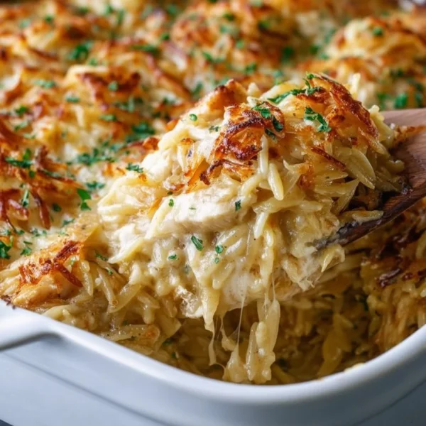 Delicious French Onion Chicken Orzo Casserole baked with melted cheese and onions