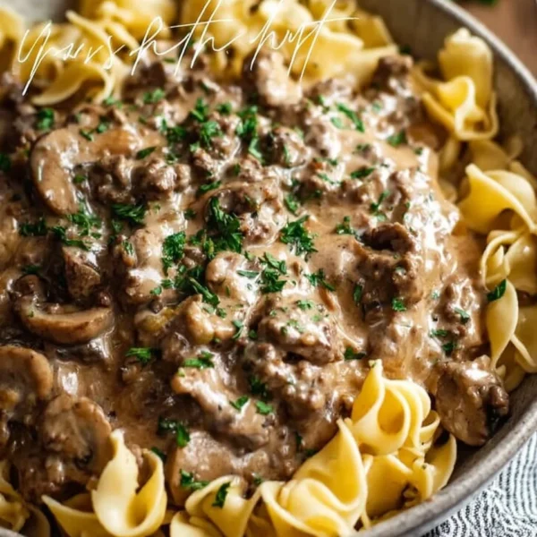 Delicious Ground Beef Stroganoff served in a creamy sauce over pasta