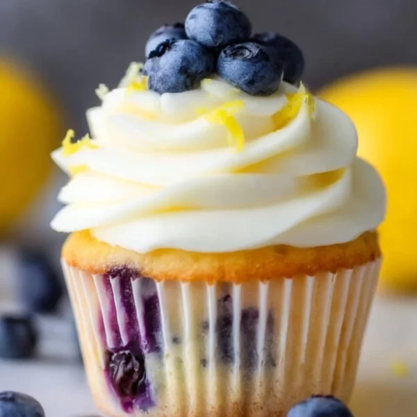 Lemon blueberry cupcakes topped with creamy frosting and fresh blueberries