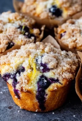 Lemon Blueberry Streusel Muffins topped with crumbles and fresh blueberries