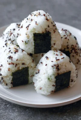 Homemade Onigiri Japanese rice balls with various fillings and seaweed wrap