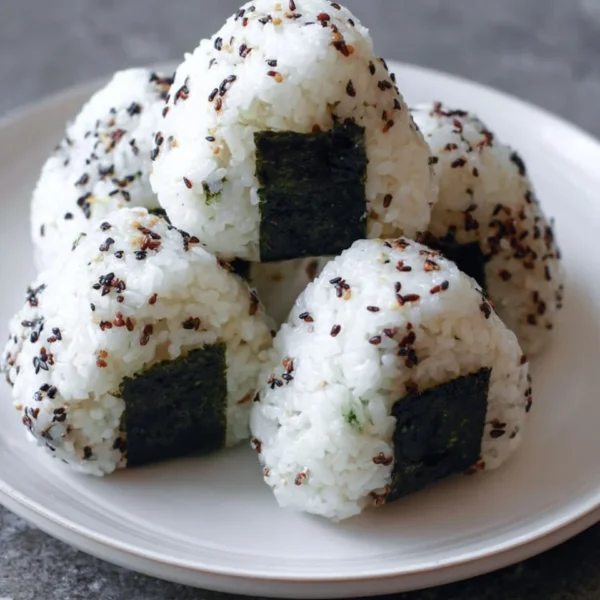 Homemade Onigiri Japanese rice balls with various fillings and seaweed wrap