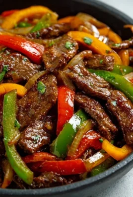 A delicious plate of Pepper Steak with Bell Peppers and Onion, showcasing vibrant colors and textures.