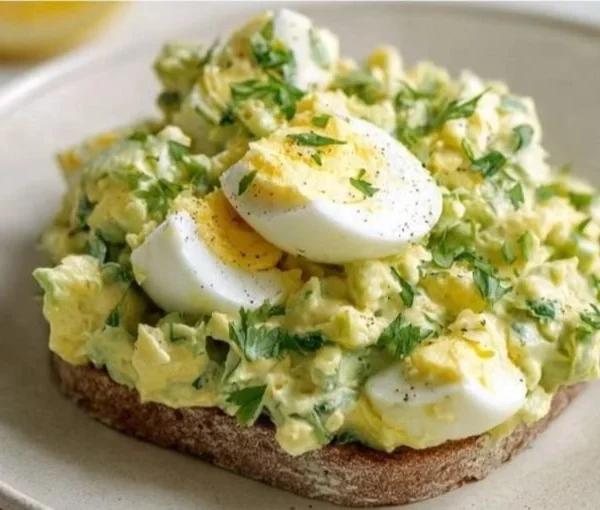 Mediterranean avocado egg salad with fresh ingredients in a bowl