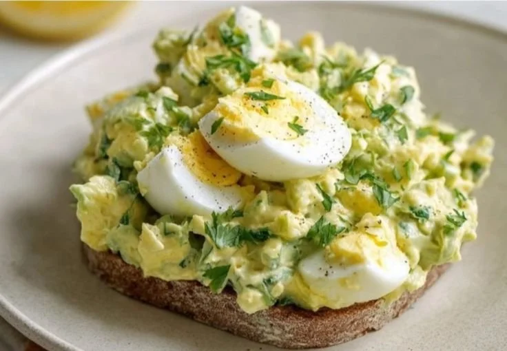Mediterranean avocado egg salad with fresh ingredients in a bowl