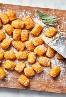 Plate of homemade sweet potato gnocchi with herbs and sauce