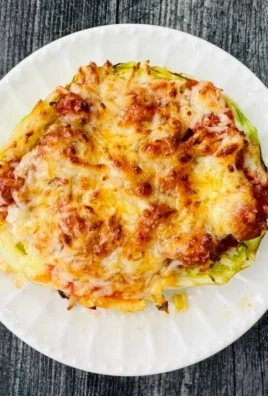 Crispy air fryer cabbage steaks served on a plate with herbs and spices