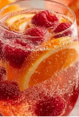 Chilled Peach Moscato Sangria in a glass with fresh fruit slices