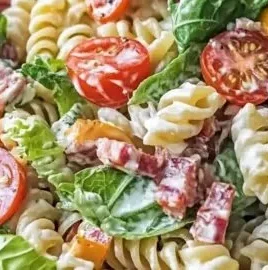 Fresh pasta salad with chopped tomatoes, avocado, and bacon served in a bowl