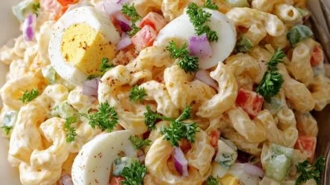 Classic macaroni salad with creamy mayo dressing in a bowl