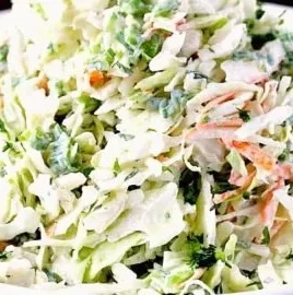 Creamy Cilantro Lime Coleslaw served in a bowl with fresh ingredients