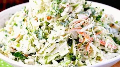 Creamy Cilantro Lime Coleslaw served in a bowl with fresh ingredients