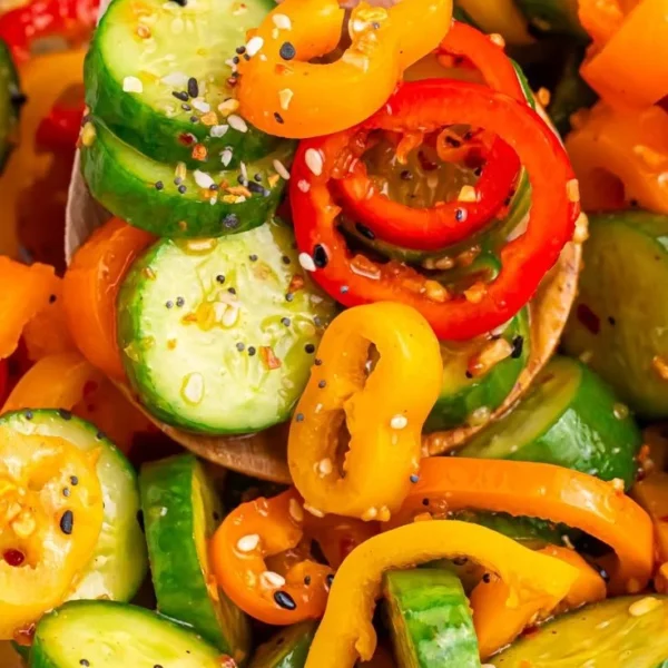Cucumber and sweet pepper salad in a bowl with fresh ingredients.