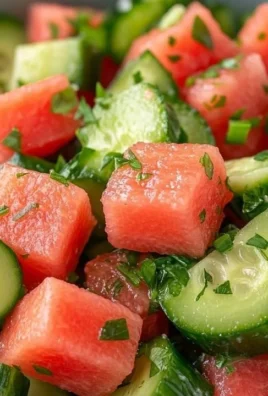 A vibrant watermelon cucumber salad with fresh herbs, colorful ingredients, and a light dressing.